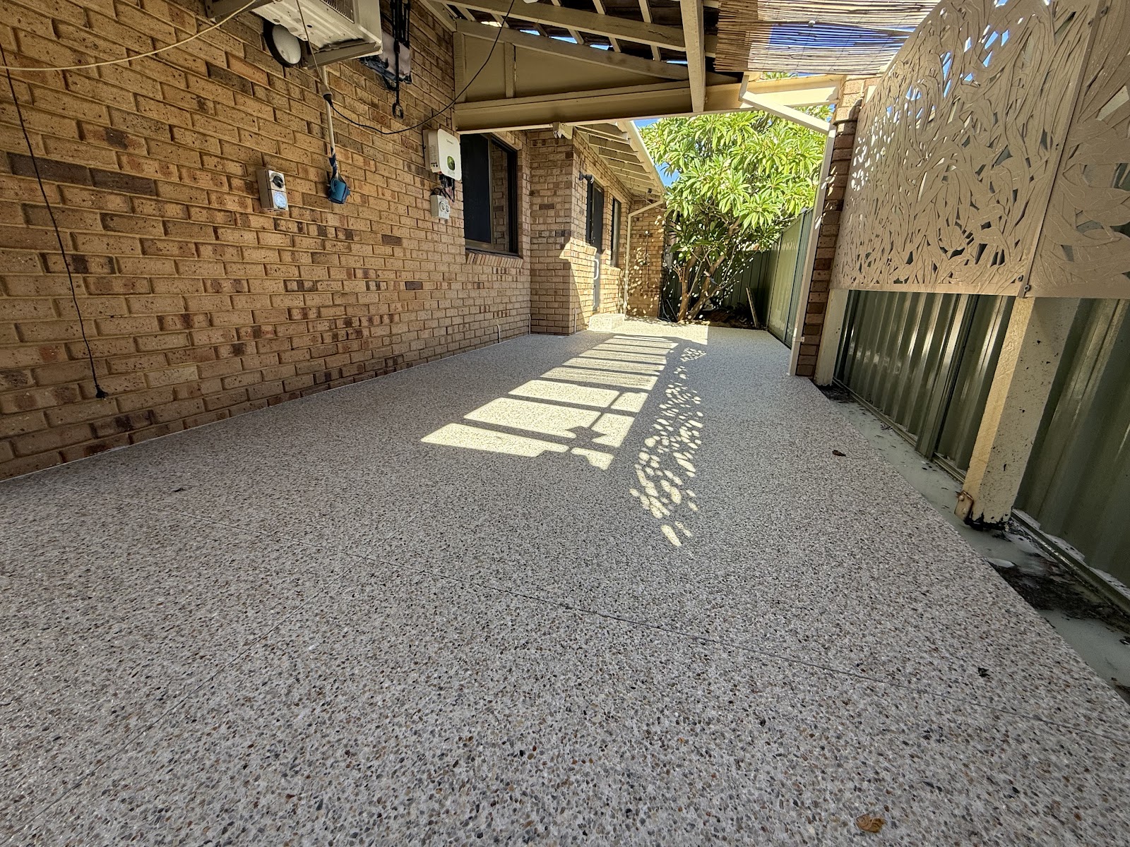 Exposed aggregate laid through a brick alfresco and side return