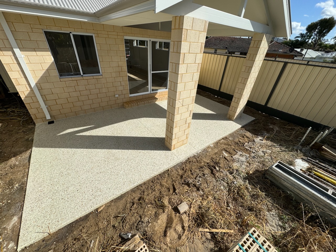 Fresh honed patio poured at a new limestone-block build