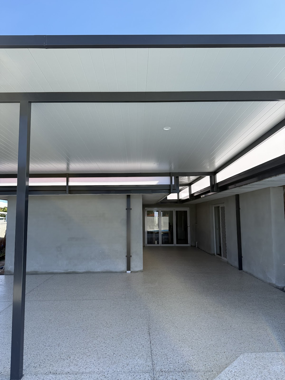 Large honed alfresco under a flat roof, poured as one clean surface
