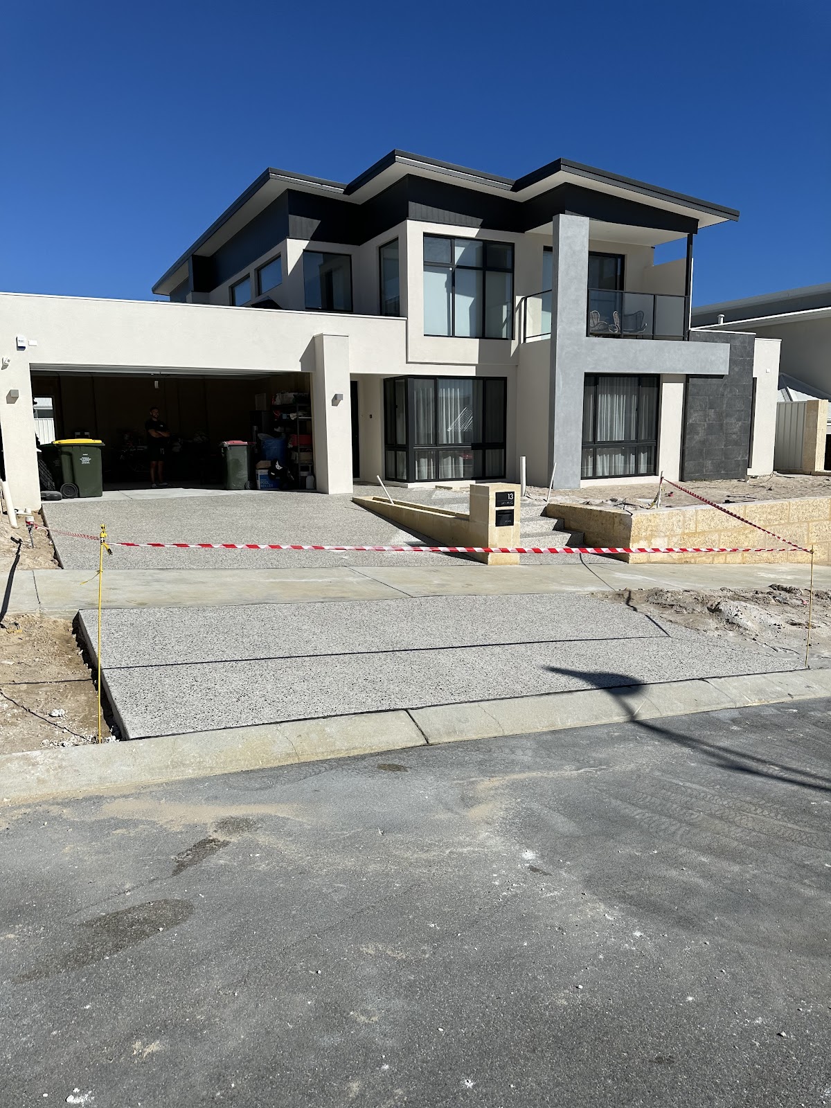 New exposed aggregate driveway taped off while it cures