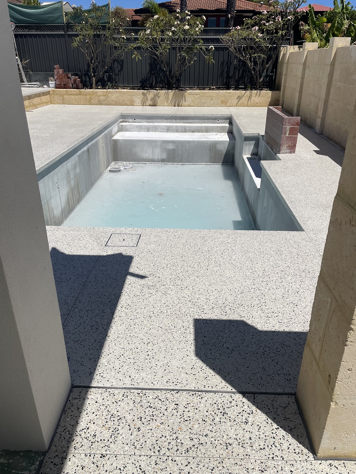 Honed surround finished around a pool still under construction
