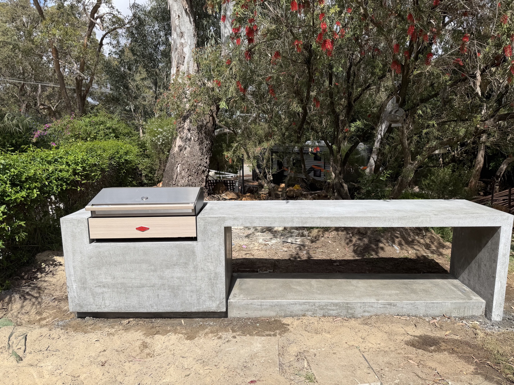 Front elevation of the Kalamunda outdoor BBQ bench, one continuous concrete form with open shelf